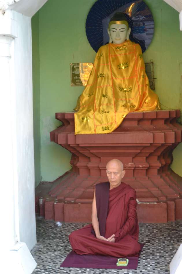 A solitary monk meditates in one of several shrines